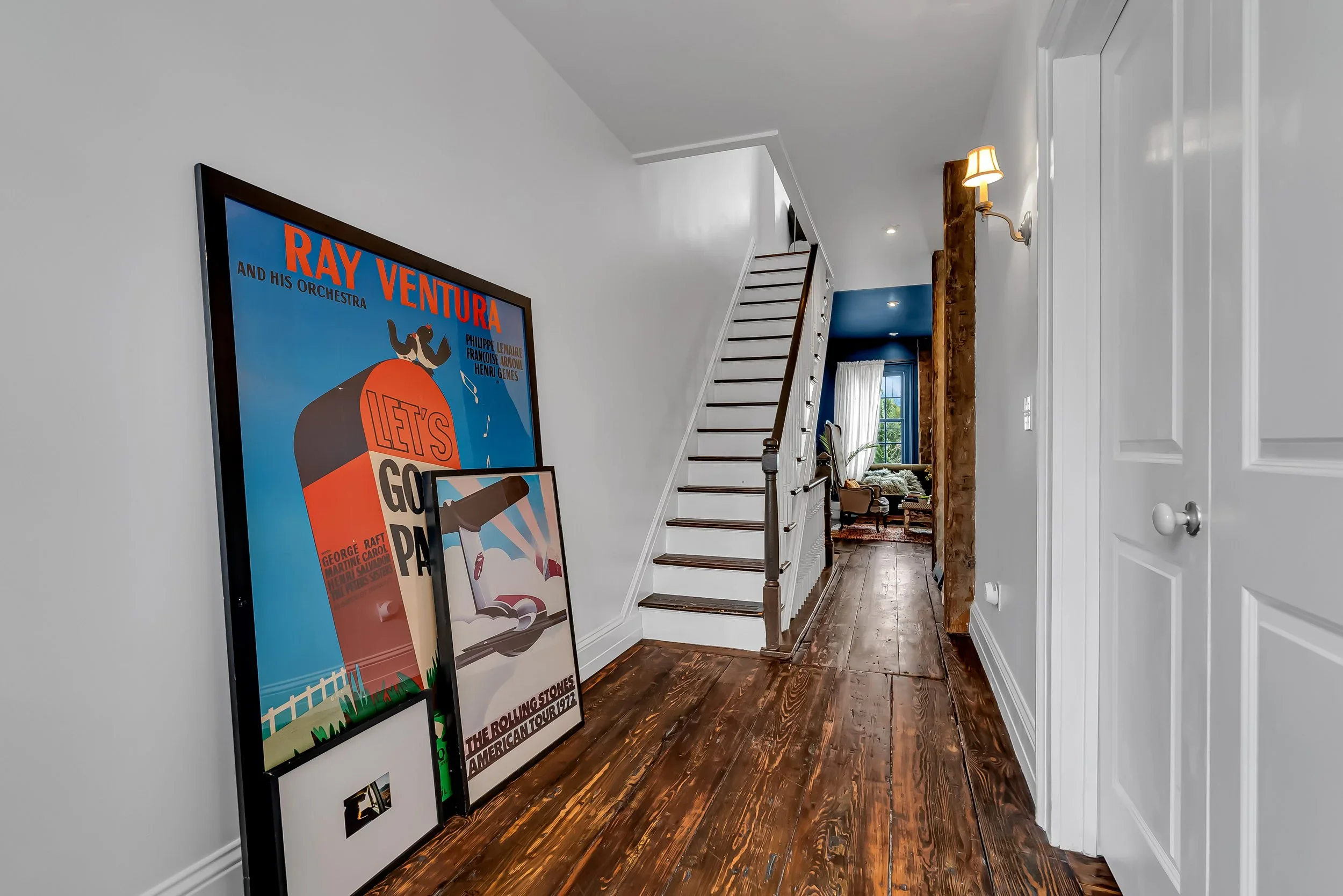 Second-floor hall lined with artwork connecting the private rooms
