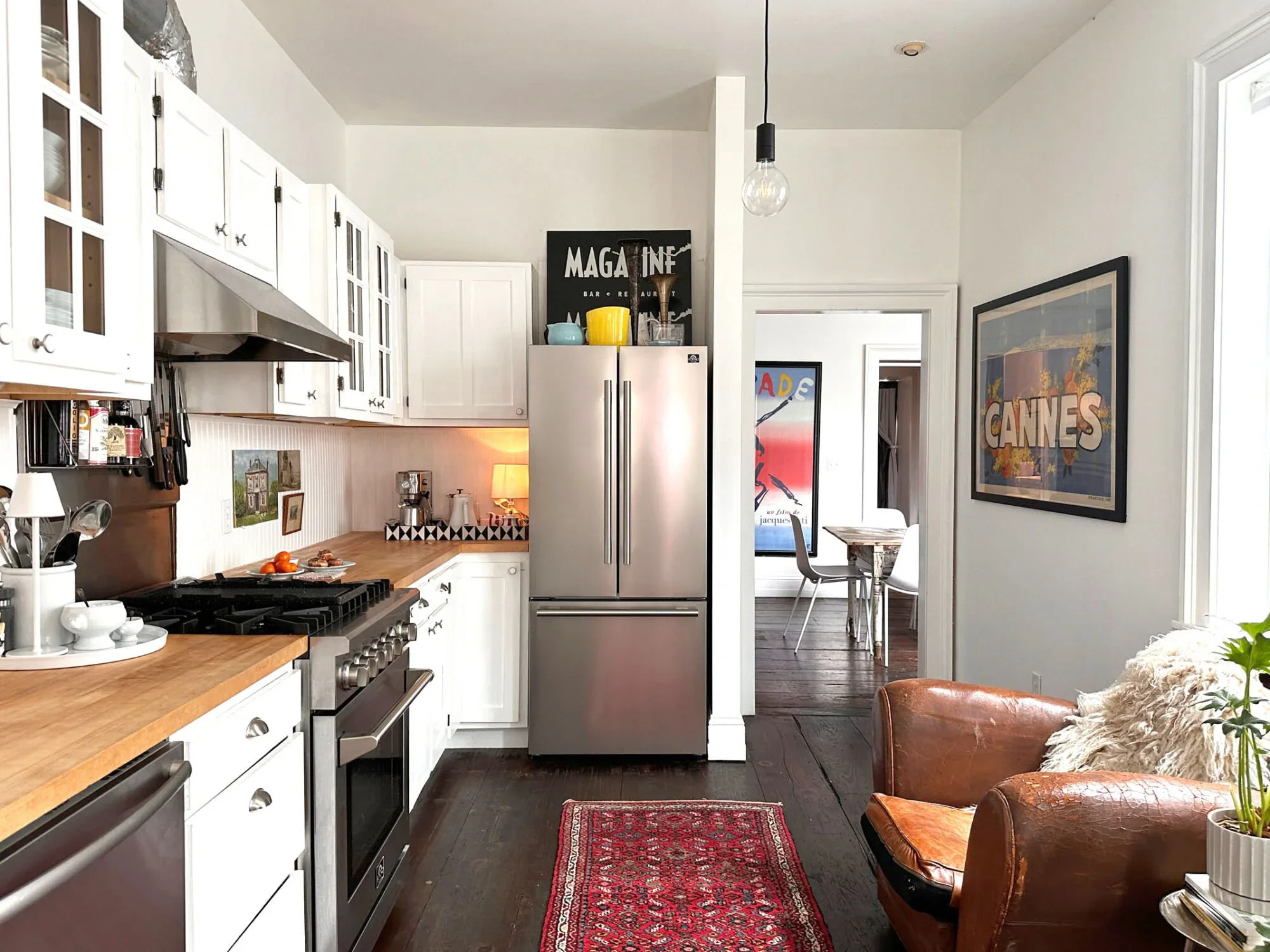 Kitchen at Long Story Short blending historic cabinetry with modern appliances and open shelving
