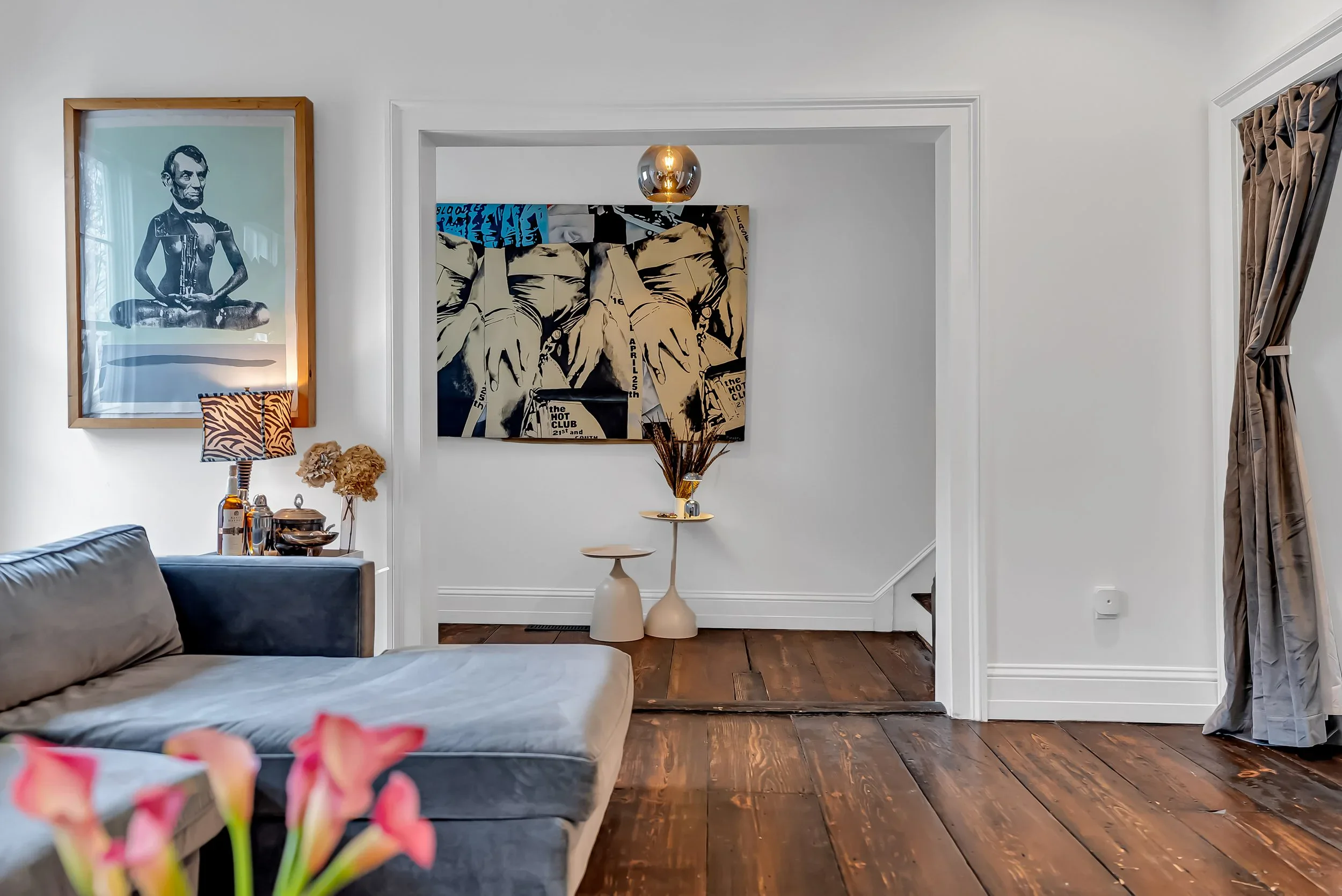 Sunlit living room with collected art, vintage furniture, and soft natural light